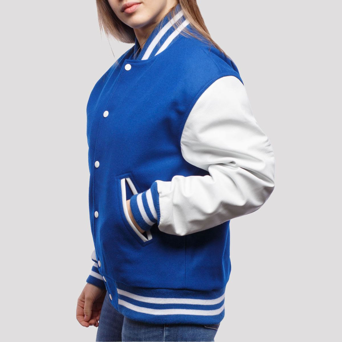 Classic royal blue wool letterman jacket with white leather sleeves, showcasing timeless varsity style.