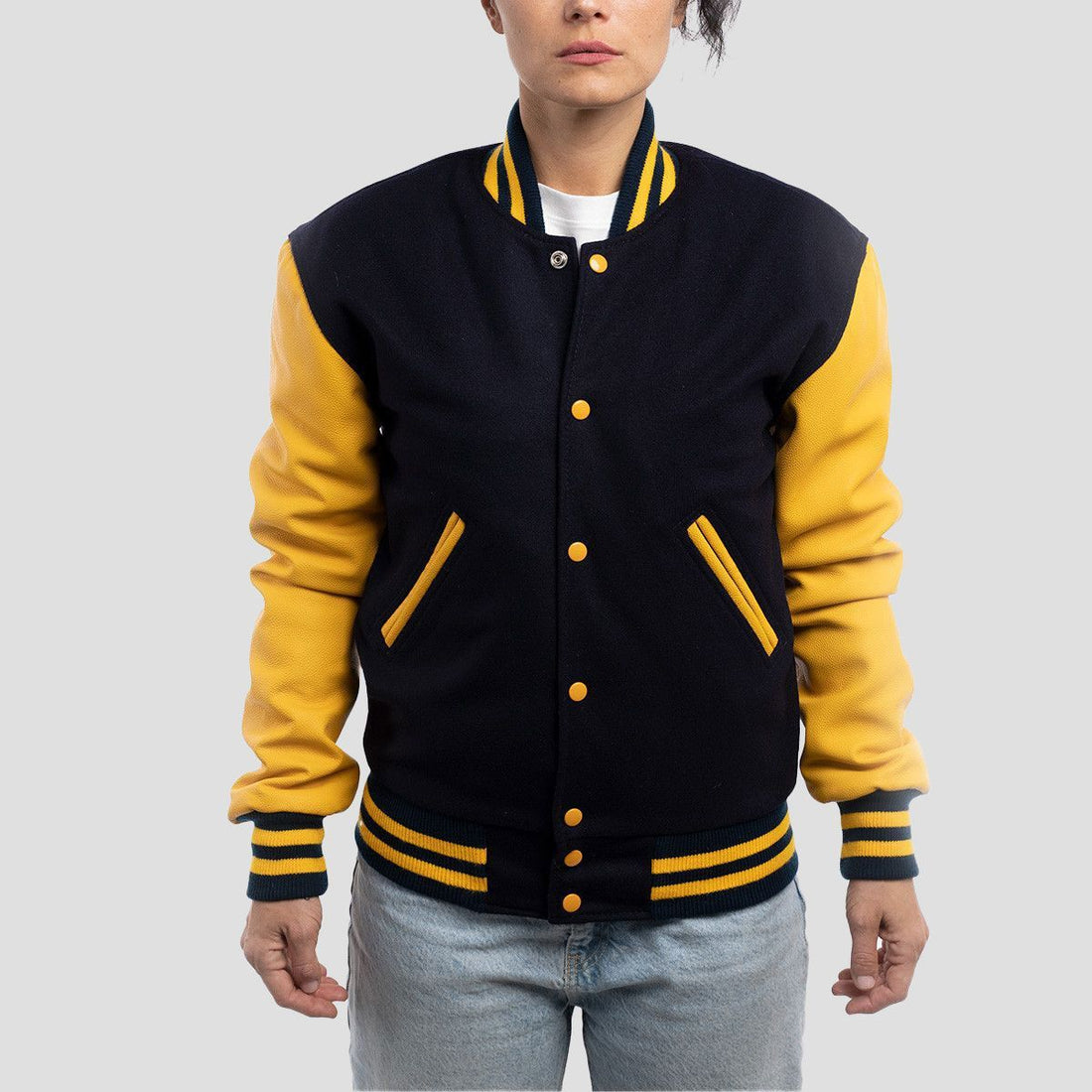 Navy blue wool letterman jacket featuring vibrant lemon leather sleeves, offering a unique and stylish look