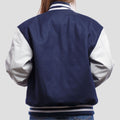Chic royal blue wool letterman jacket with contrasting white leather sleeves, designed for a sophisticated touch
