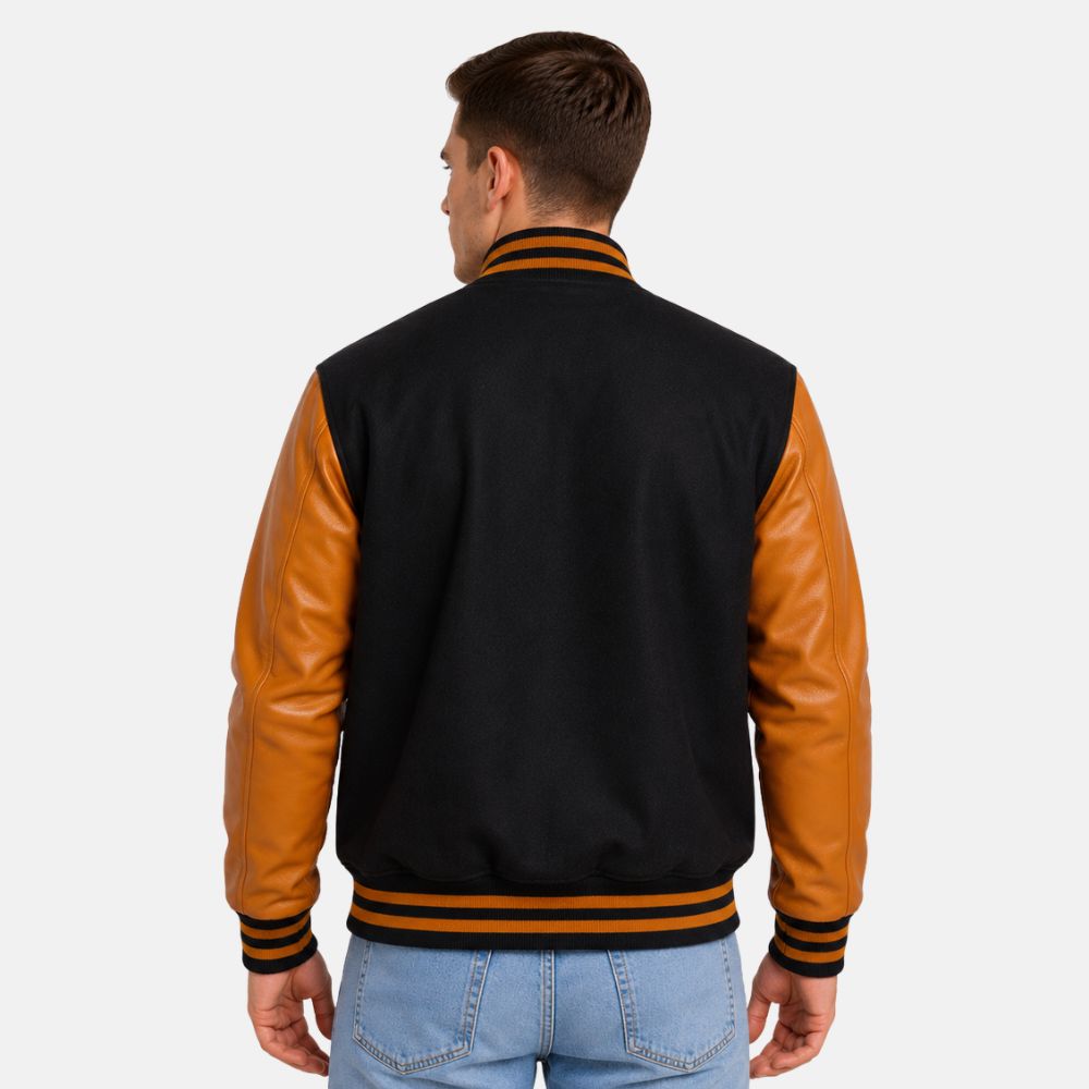 Back view of men’s black wool varsity jacket with gold leather sleeves and striped varsity waistband.