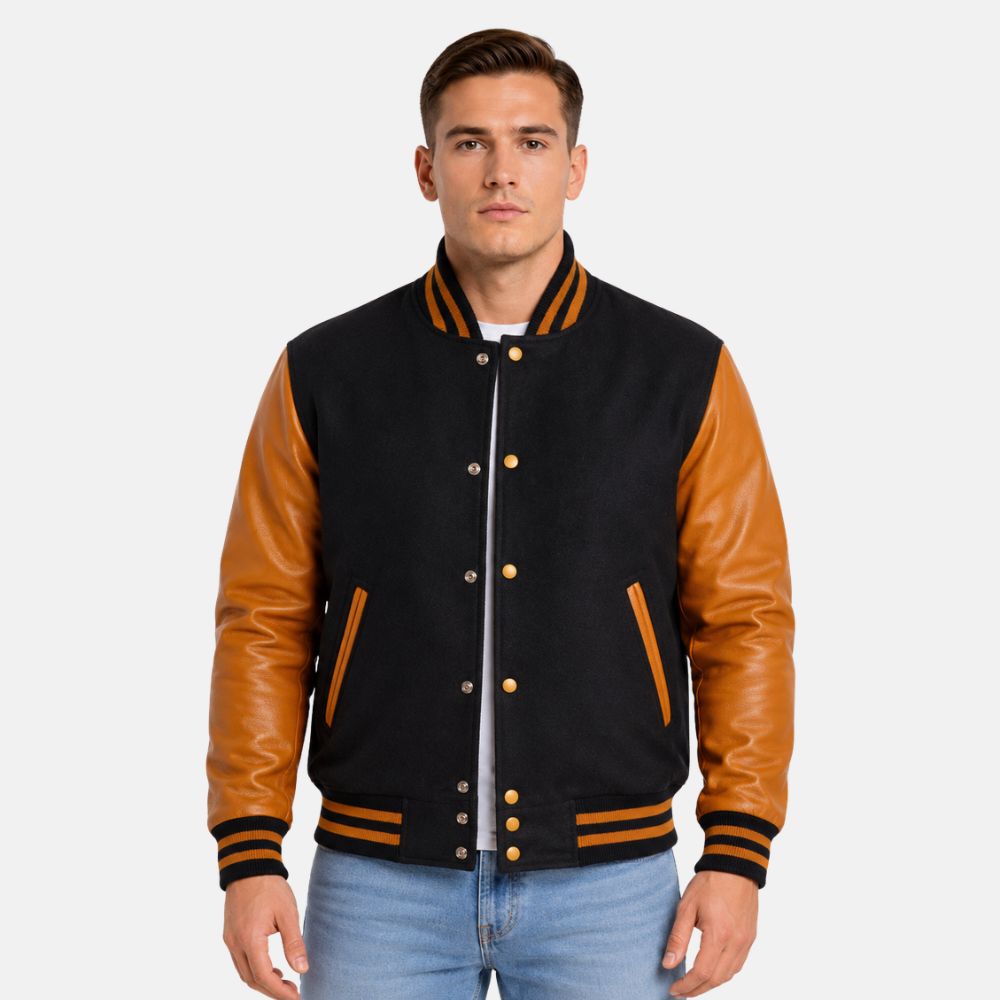 Men’s black and gold letterman jacket with premium wool body and gold leather sleeves on a gray background.