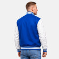 Back view of royal blue wool varsity jacket with white leather sleeves and striped ribbed waistband and collar.