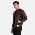 Man wearing a brown leather jacket with white stripes on a white background