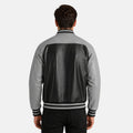 Person wearing a gray and black jacket on a white background