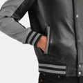 Close-up of a black leather jacket with gray accents on a white background