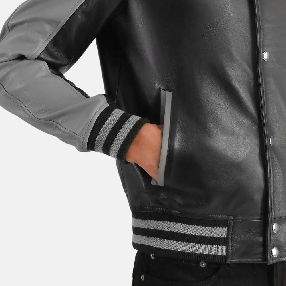 Close-up of a black leather jacket with gray accents on a white background