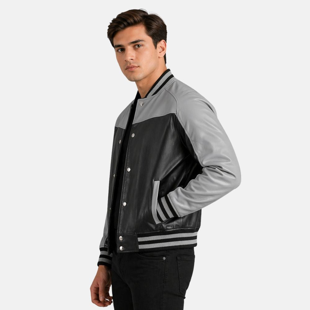 Man wearing a gray and black varsity jacket on a white background