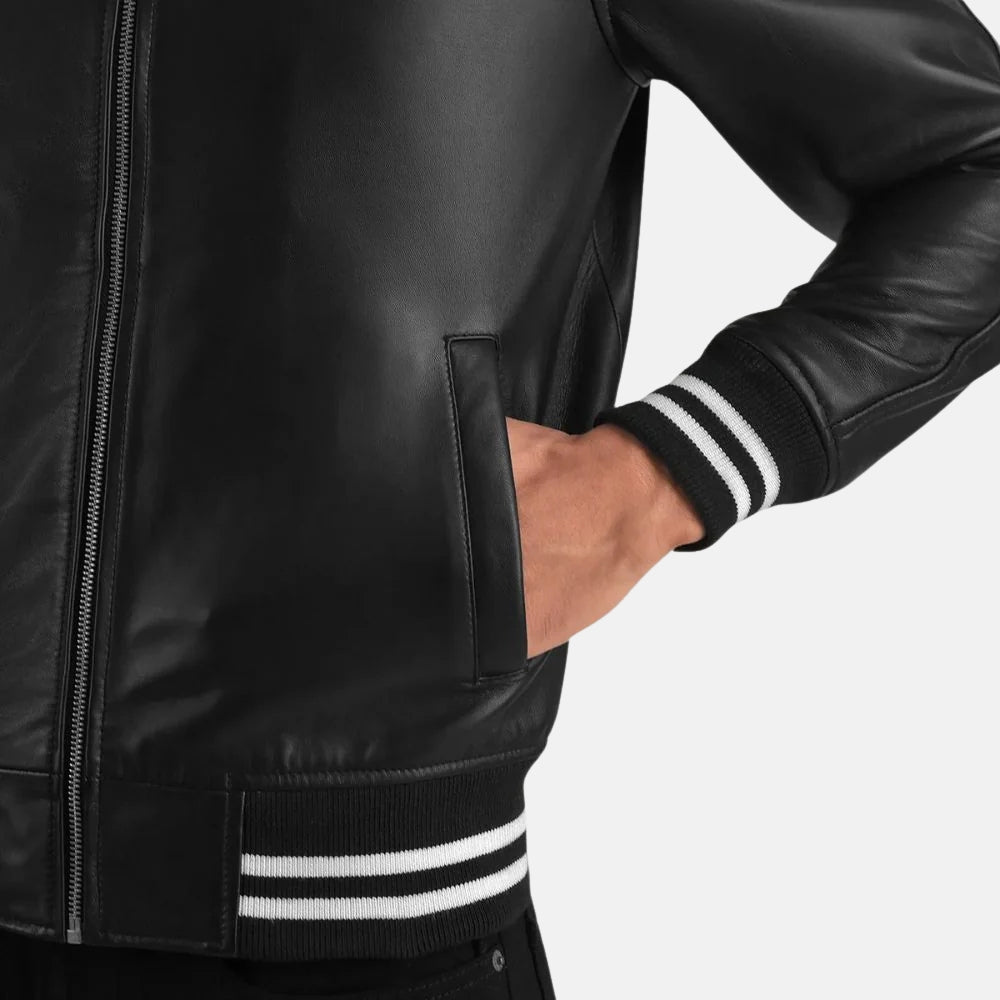 Black leather jacket with white stripes on cuffs and waistband against a light gray background