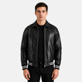 Man wearing a black leather jacket with white stripes on a light gray background