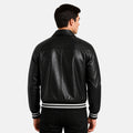 Man wearing a black leather jacket with white stripes on a white background