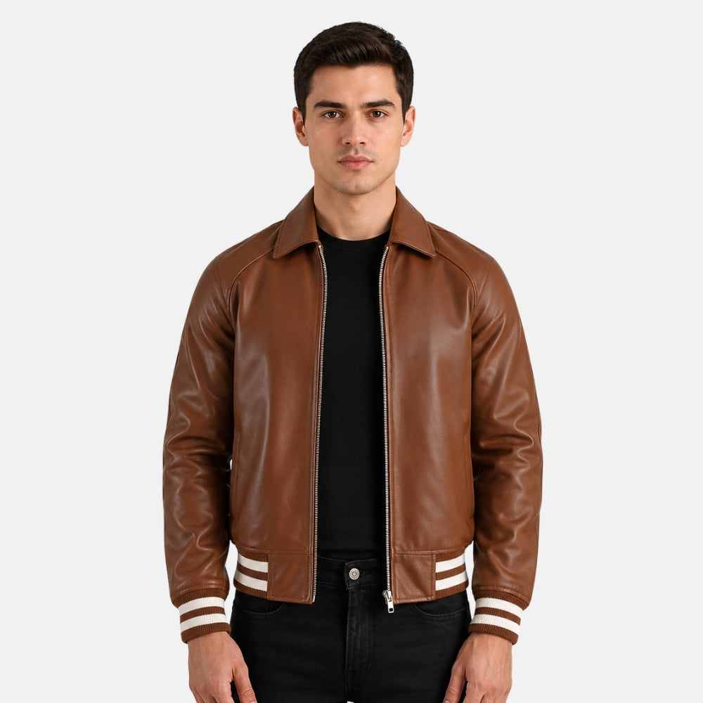 Man wearing a brown leather jacket with white trim on a plain background