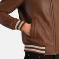 Brown leather jacket with striped cuffs on a white background