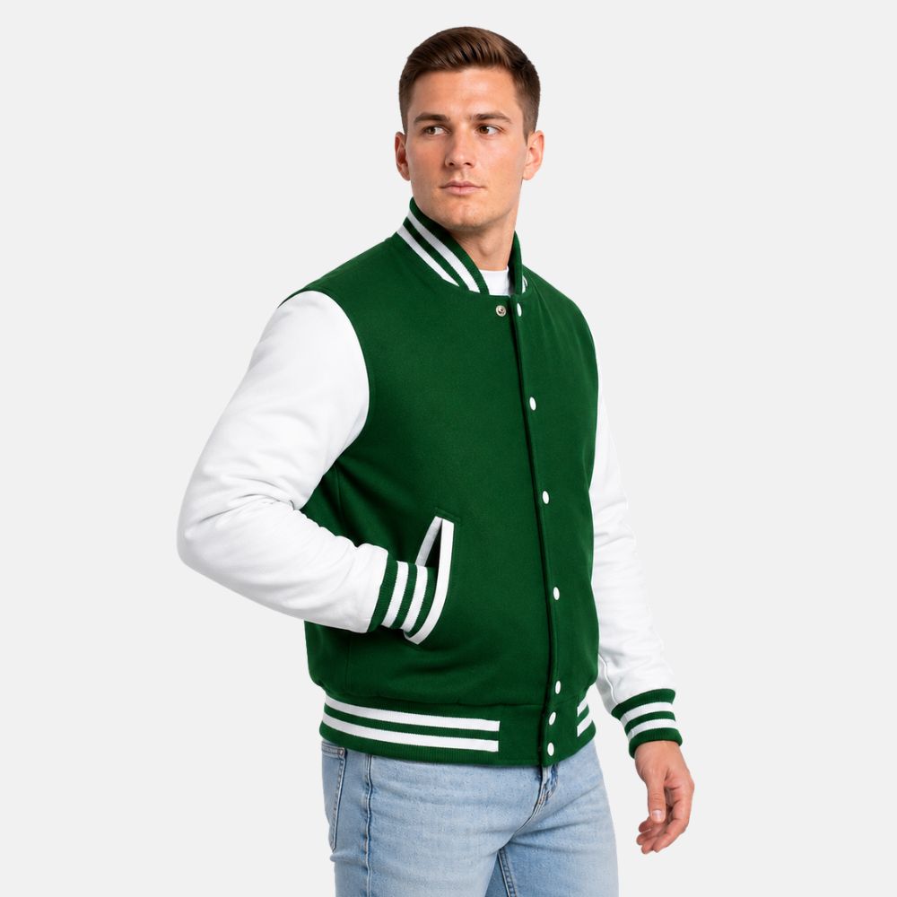 Men wearing a Kelly green wool varsity jacket with white leather sleeves and striped ribbed trims on a light gray background.