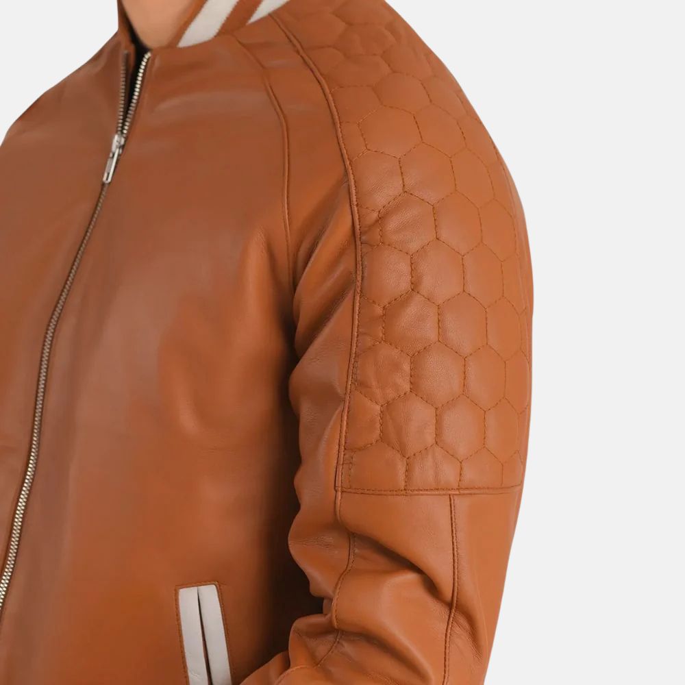 Brown leather jacket with quilted shoulder design on a white background