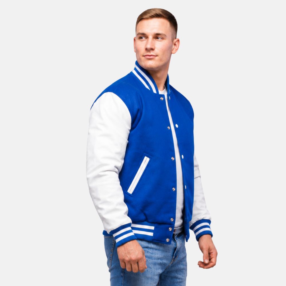 Men’s royal blue wool letterman jacket with white leather sleeves, ribbed striped collar, cuffs, and front snap closure.