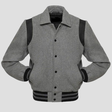 A grey wool letterman-style jacket with black leather sleeves and rib-knit trim on the collar, cuffs, and hem, featuring a snap button closure.