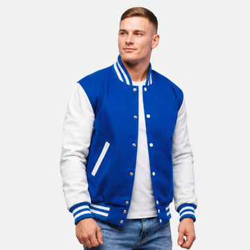Men’s royal blue wool letterman jacket with white leather sleeves, ribbed striped collar, cuffs, and front snap closure.