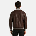 Man wearing a brown leather jacket with white stripes on a white background