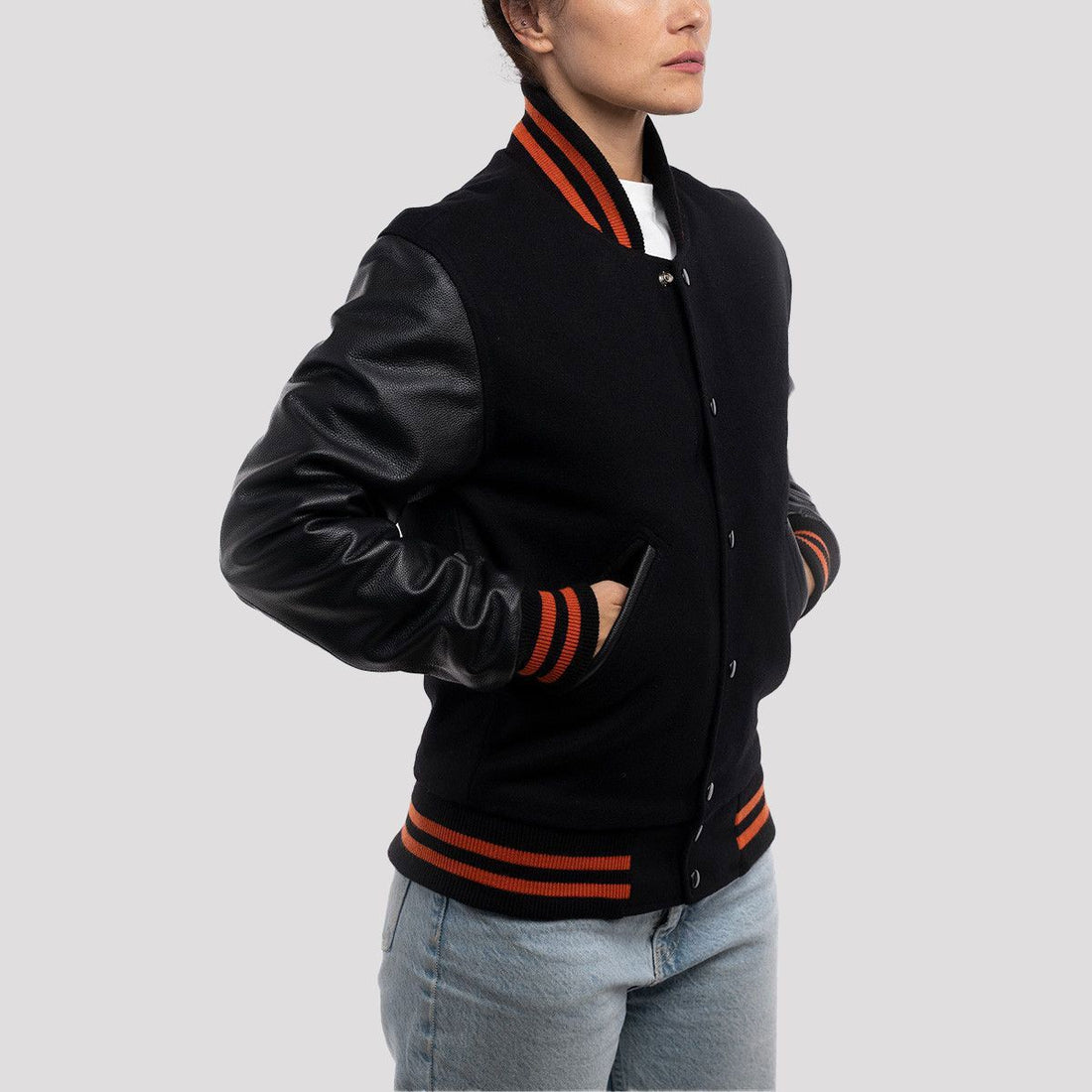 Sleek black body varsity jacket with bright orange stripes on the cuffs and collar, offering a bold and sporty look