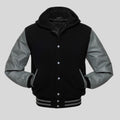 Black and gray varsity jacket with a hood on a light gray background