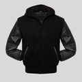 Black jacket with leather sleeves on a gray background