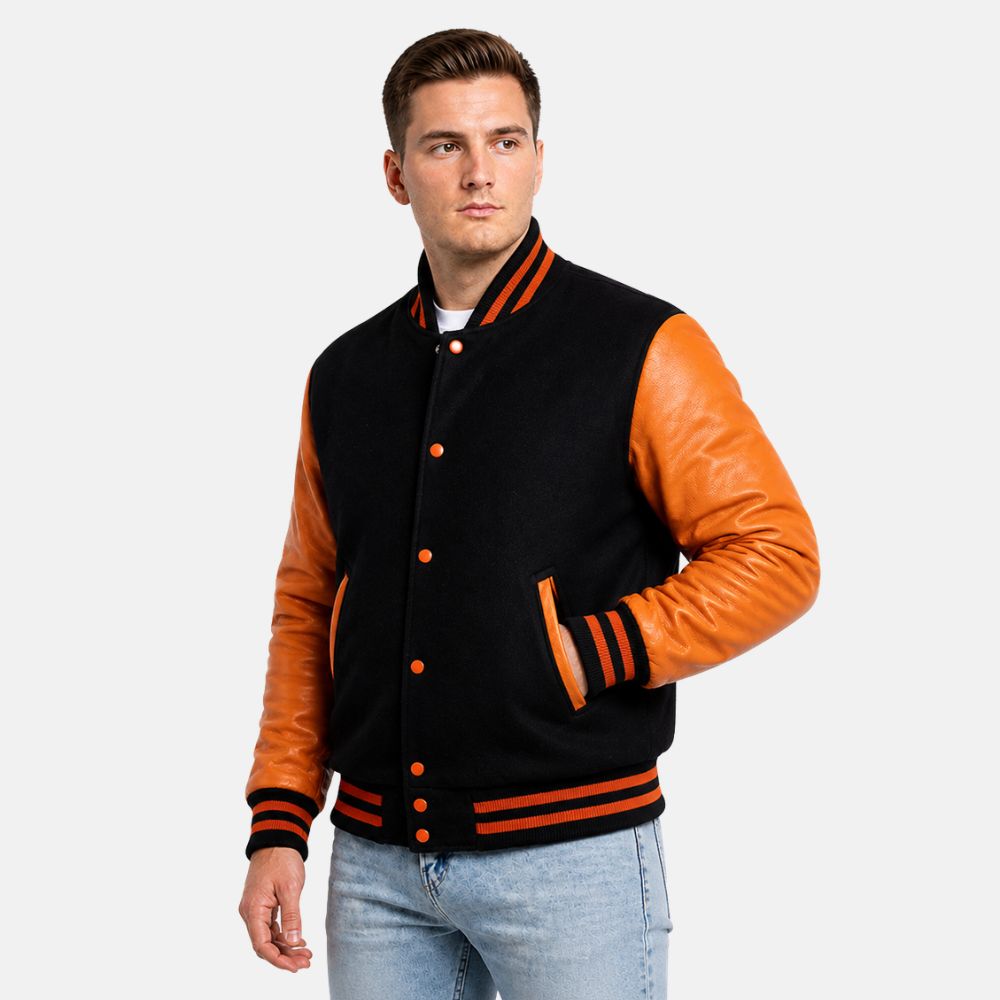 Man wearing a black and orange varsity jacket on a white background
