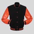 Black letterman jacket with orange sleeves on a gray background