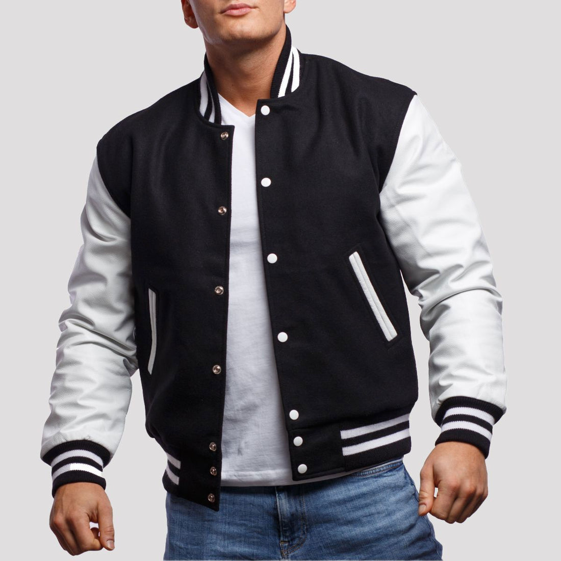 Classic black and white letterman jacket with white sleeves and striped cuffs, perfect for casual or streetwear styles