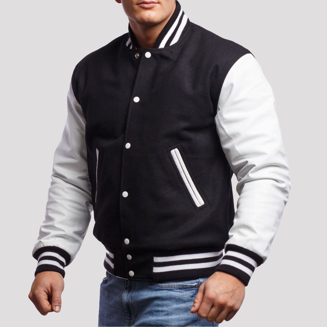 Classic black and white letterman jacket with white sleeves and striped cuffs, perfect for casual or streetwear styles