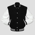 A classic men's varsity jacket with a black wool body and white vinyl sleeves, featuring a traditional snap button closure, rib-knit trim on the collar, cuffs, and waistband, and designed in a black and white color scheme.