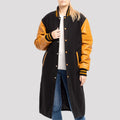 Classic black wool letterman coat with old gold leather sleeves, combining timeless varsity style with a luxurious finish