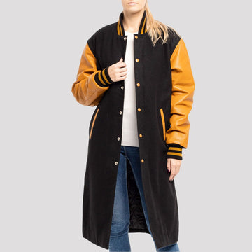 Classic black wool letterman coat with old gold leather sleeves, combining timeless varsity style with a luxurious finish