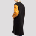 Trendy black wool and old gold leather sleeve letterman coat, ideal for adding a touch of elegance to casual outerwear