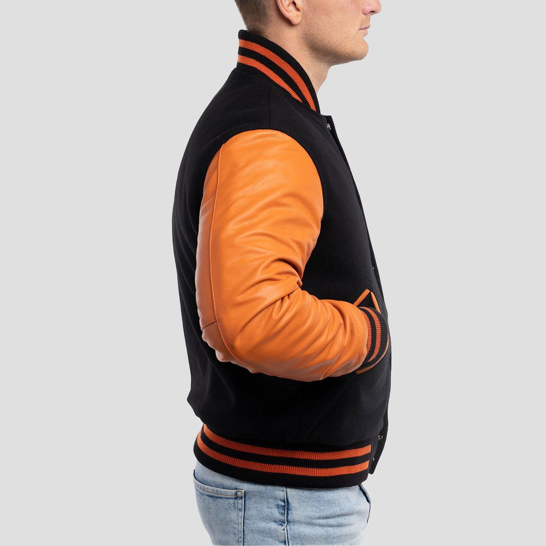 Classic fit black wool varsity jacket with bold orange leather sleeves, perfect for a sporty and timeless look