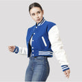 Trendy bright royal blue crop top varsity jacket with contrasting white sleeves, offering a modern twist on a classic style.