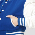 Bright royal blue varsity jacket with white sleeves and a cropped design, ideal for adding a sporty edge to any outfit