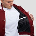 Cardinal red wool varsity jacket with white leather sleeves and a classic fit, ideal for casual or athletic wear.