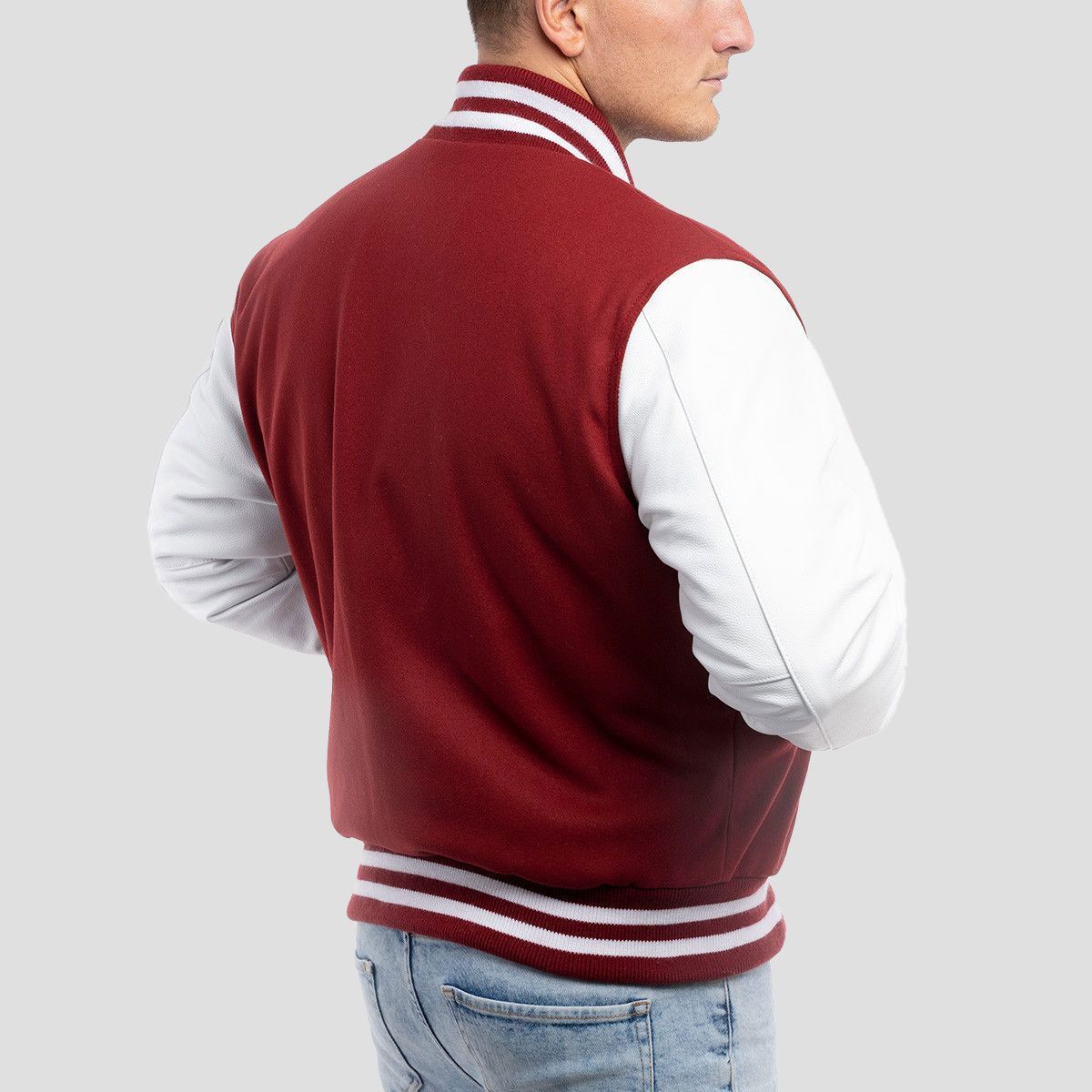 Stylish cardinal red wool varsity jacket with contrasting white leather sleeves, blending classic fit with standout colors