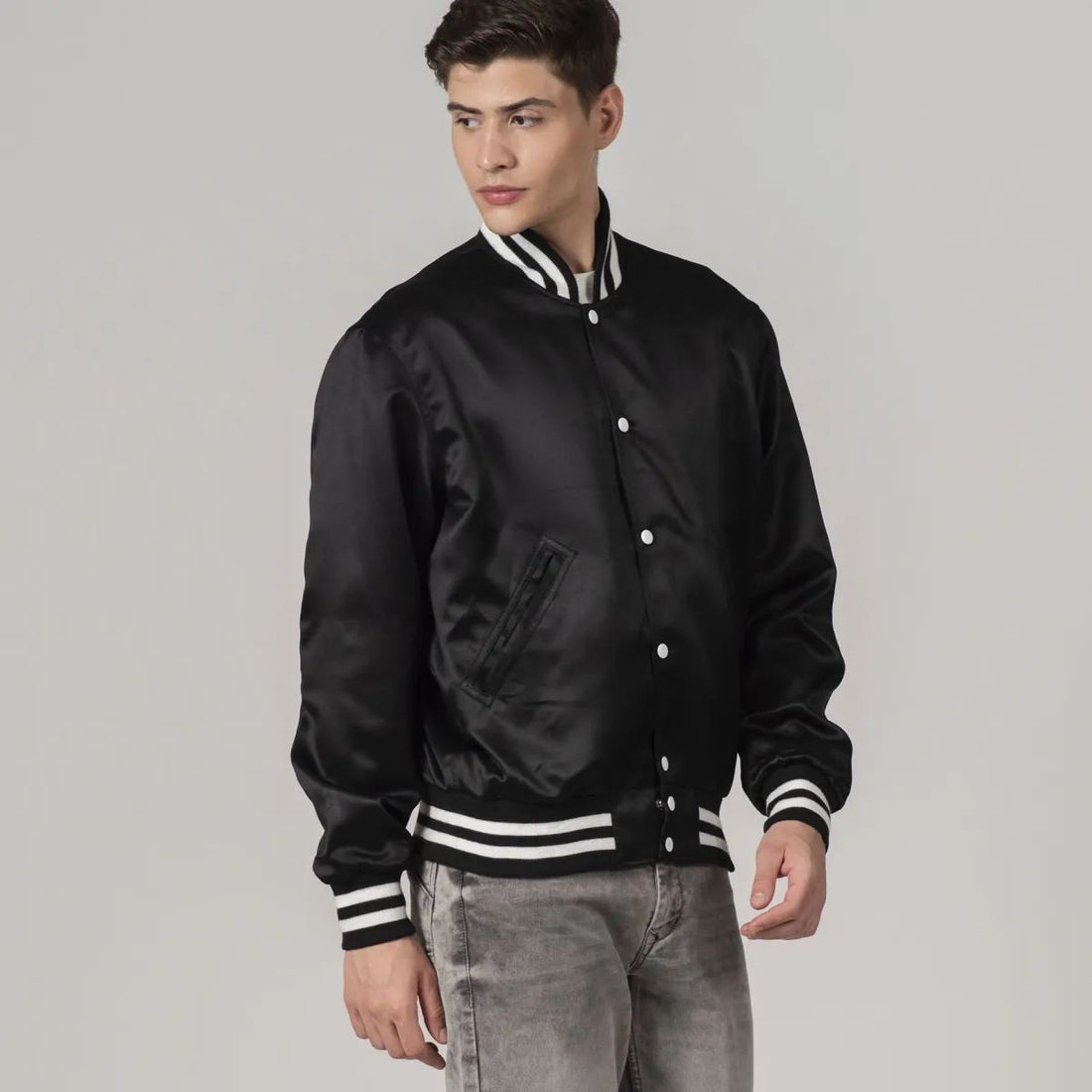 Classic black satin letterman jacket with white striped trims, offering a sleek and stylish varsity look