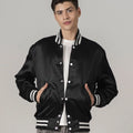 Stylish black satin letterman jacket with contrasting white striped trims, blending luxury fabric with sporty details