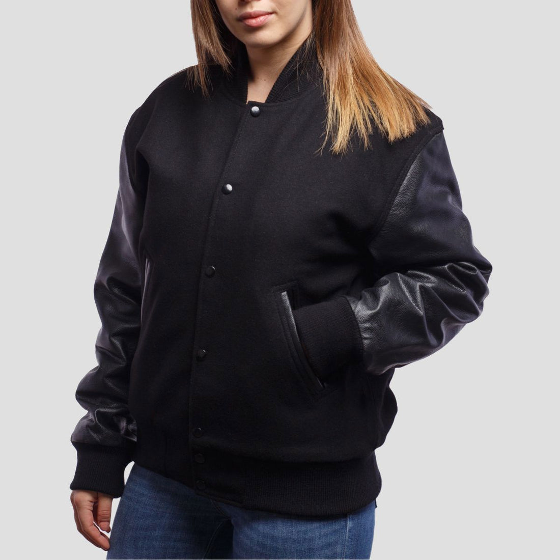 Classic black wool letterman jacket with sleek leather sleeves, offering a timeless varsity style