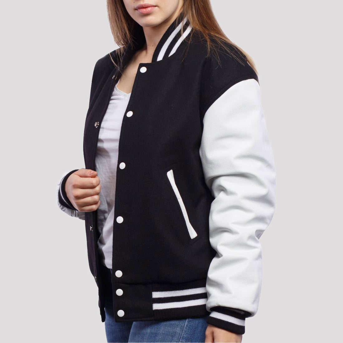 Classic black wool letterman jacket with white leather sleeves, offering a timeless varsity style with bold contrast