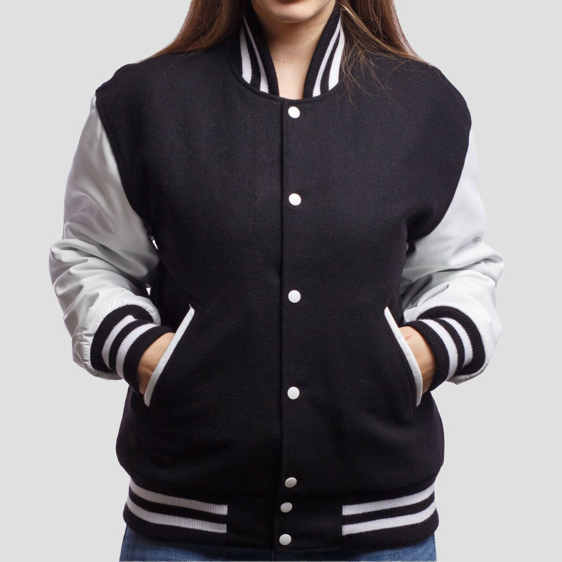 Classic black wool letterman jacket with white leather sleeves, offering a timeless varsity style with bold contrast