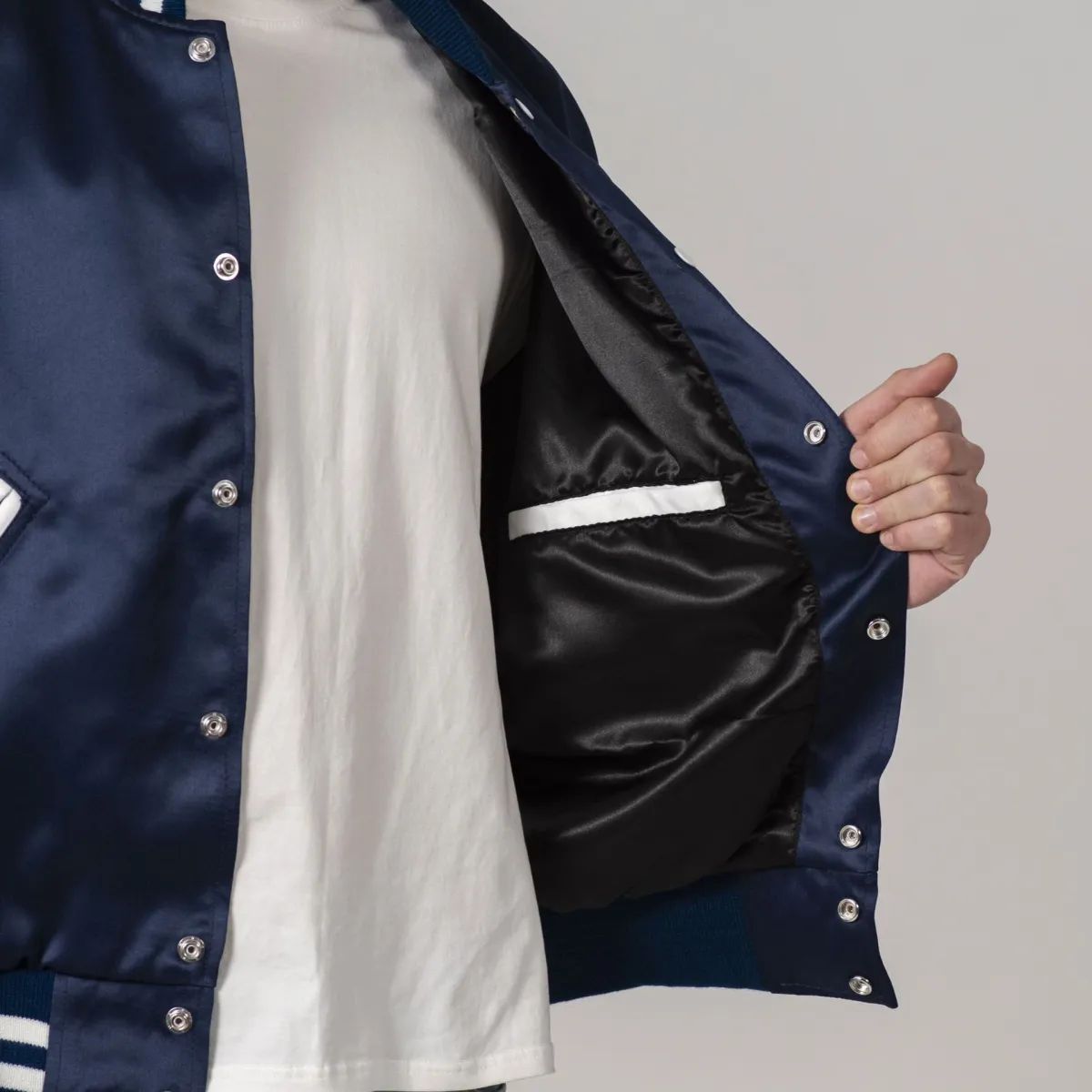 Navy blue satin letterman jacket with white sleeves for a classic look