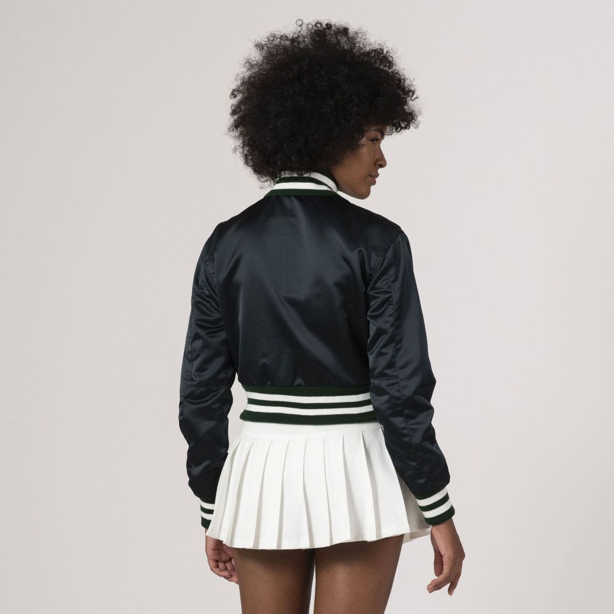 Fashion-forward Dartmouth green satin crop varsity jacket with cropped length and varsity-inspired details