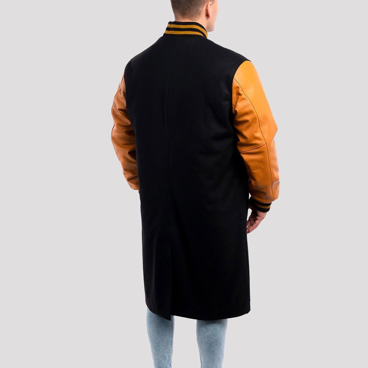 Stylish black wool letterman coat with unique old gold leather sleeves, designed for a refined, athletic style