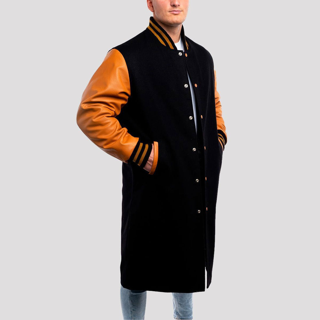 Elegant black wool letterman coat with luxurious old gold leather sleeves, blending classic and modern style