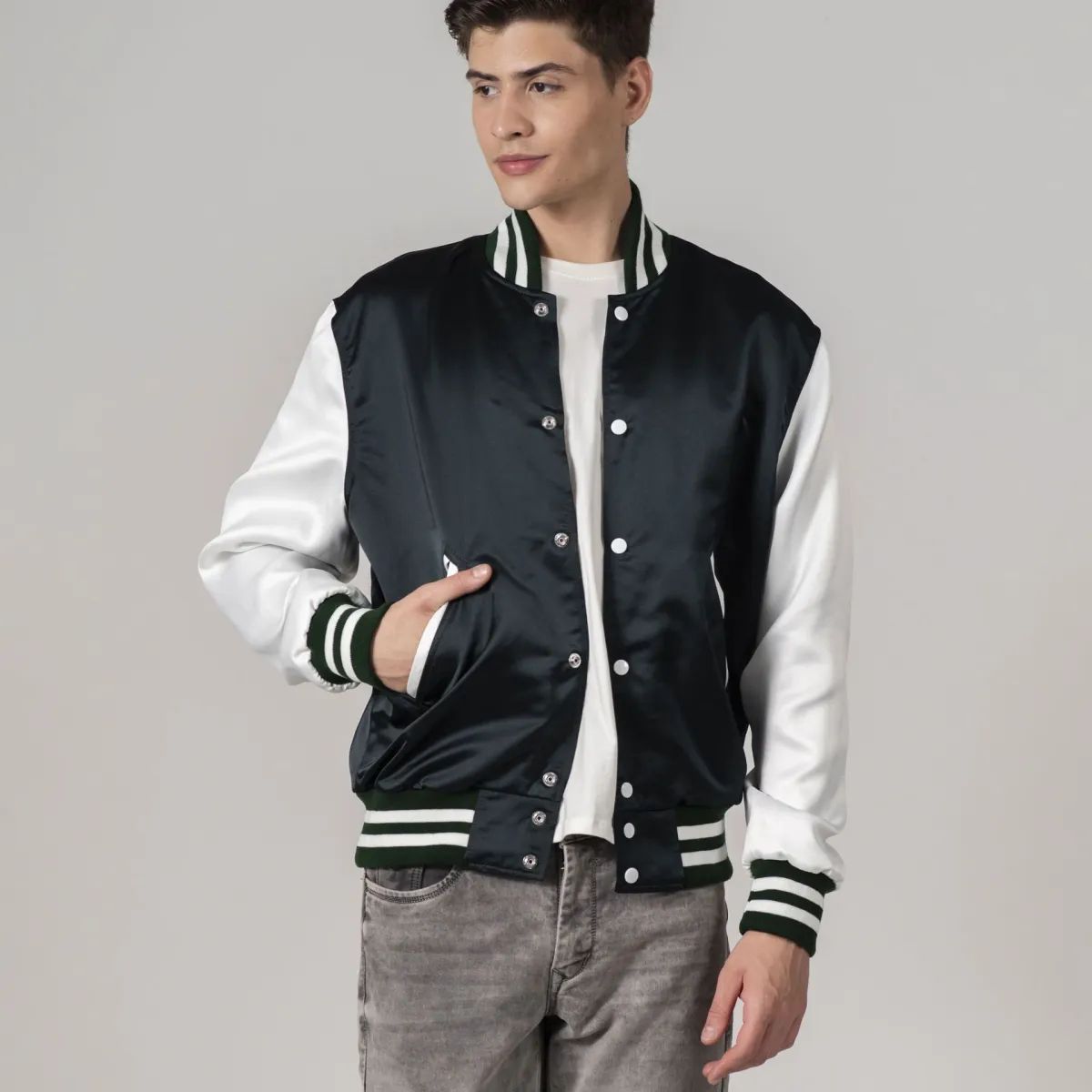 Stylish forest green varsity jacket in satin with bold white sleeves, perfect for a sporty look