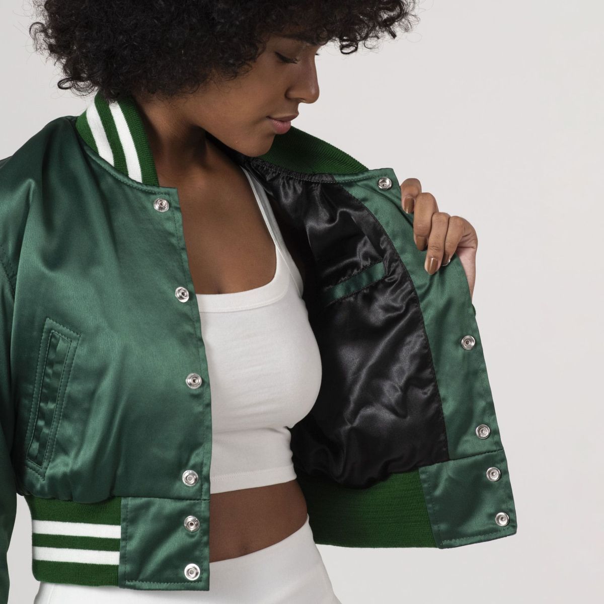 Satin crop top varsity jacket in Kelly green, ideal for layering with streetwear outfits