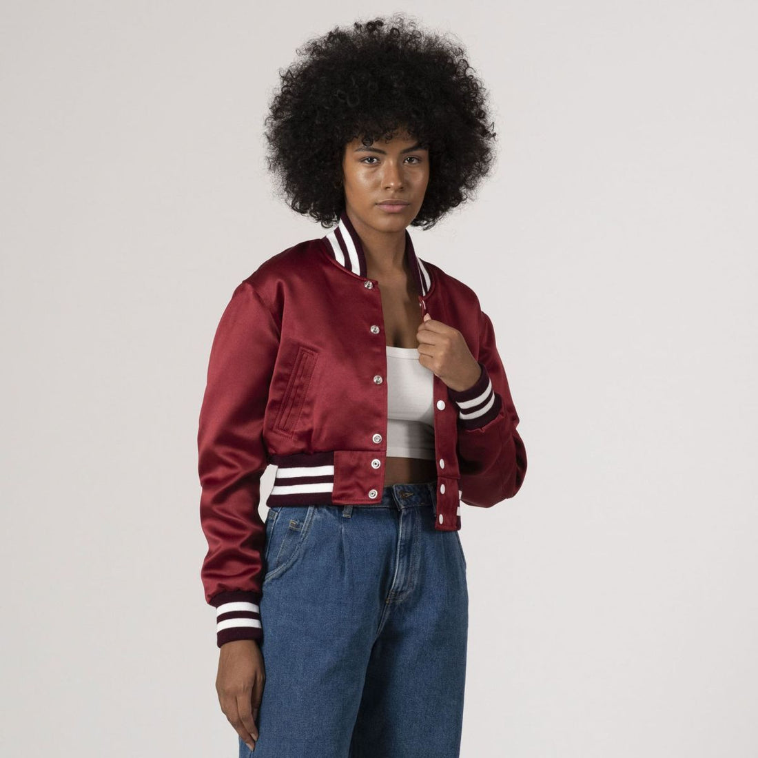 Maroon satin crop top varsity jacket with a sleek, sporty design, perfect for modern streetwear.